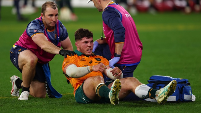 Carlo Tizzano of the Wallabies receives medical attention following a contest in the final moments of the second test of the series between Australia Wallabies and British & Irish Lions at the Melbourne Cricket Ground on July 26, 2025 in Melbourne, Australia. (Photo by Morgan Hancock/Getty Images)