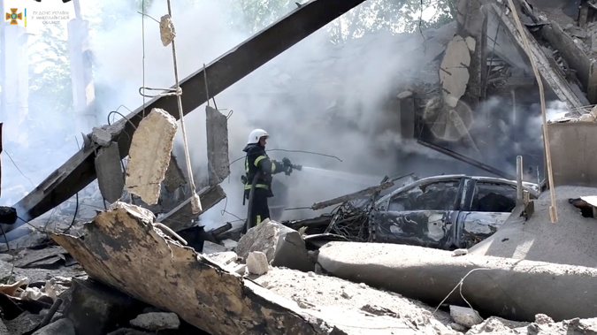 Firefighters work to extinguish a blaze after a Russian military strike in Mykolaiv in mid-July. Photo / CNN