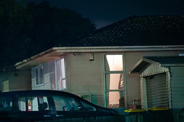 Police continue to guard the scene following a drive-by shooting in Weymouth overnight. Photo / Hayden Woodward