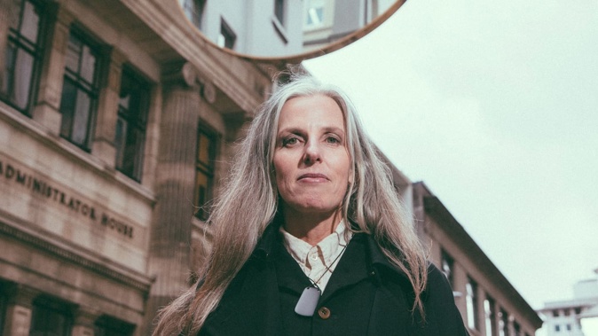 Catherine Griffiths below her artwork, Light Weight O, which hung over O'Connell St in Auckland's CBD before it was removed in 2021. File photo / Auckland Council