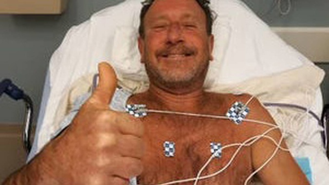 Michael Packard, 56, gives the thumbs up from hospital after being swallowed by a humpback whale. (Photo / Supplied)