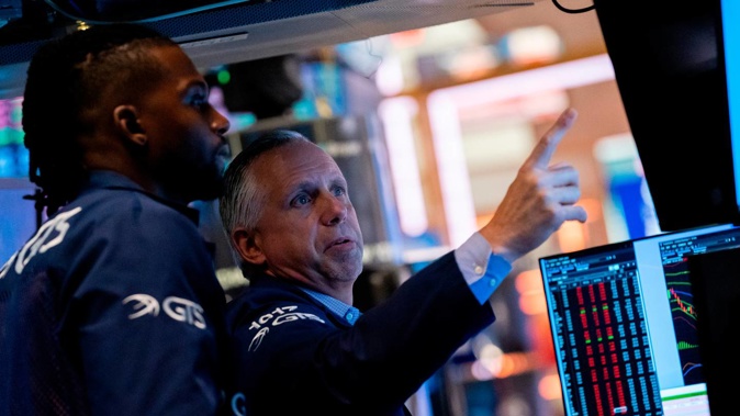Traders on the New York Stock Exchange floor. All the action stemmed from a US government report showing inflation slowed in October for a fourth straight month. Photo / AP