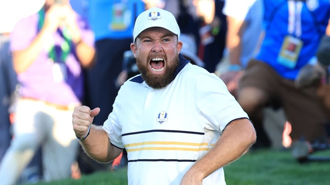 Shane Lowry of Europe celebrates holing a putt on the 18th green to retain the Ryder Cup. Photo / Getty Images