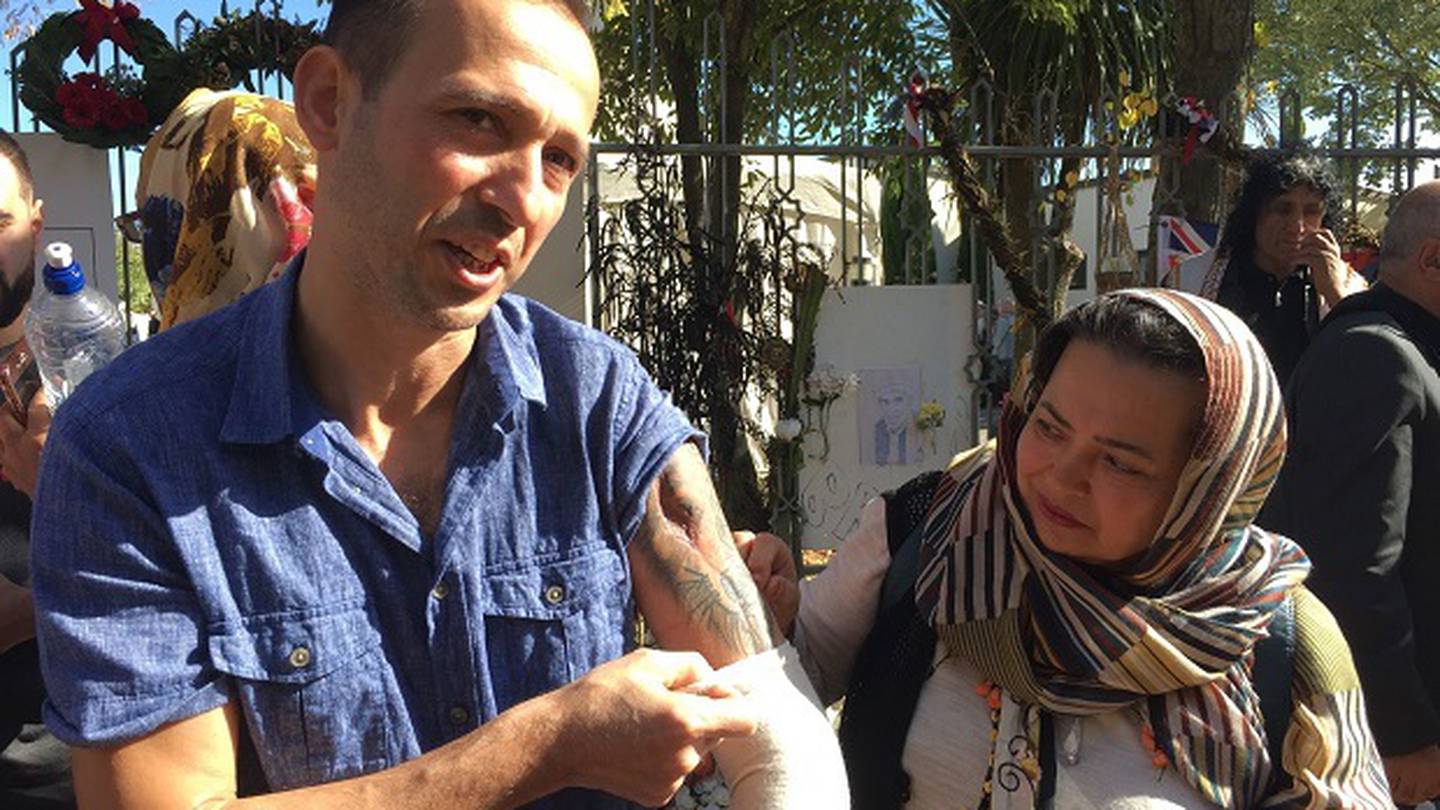 Temel Atacocugu, who was shot in the March 15, 2019, Christchurch mosque shootings, shows his wounds outside the Al Noor Masjid. Photo / Amber Allott