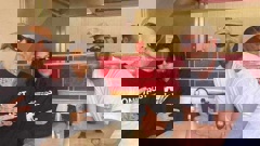 A-lister couple Travis Barker and Kourtney Kardashian posing with a customer at Wise Boys Grey Lynn.