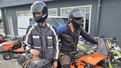 The German father and son with their motorbikes, including the recovered and seriously damaged bike (front). Photo / Connull Lang