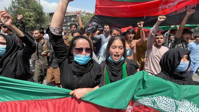 A group of people march with Afghan flags during the Afghanistan's Independence Day rally in Kabul, Afghanistan. (Photo / AP)