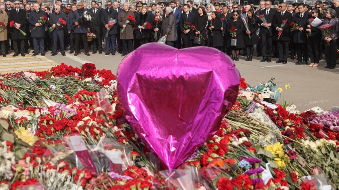 A group of ambassadors of foreign diplomatic missions attend a laying ceremony at a makeshift memorial in front of the Crocus City Hall on the western outskirts of Moscow, Russia. Photo / AP
