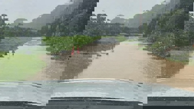 Flooding at North Piha Rd after more torrential rain hit the settlement on Tuesday. Photo / Peter McNally