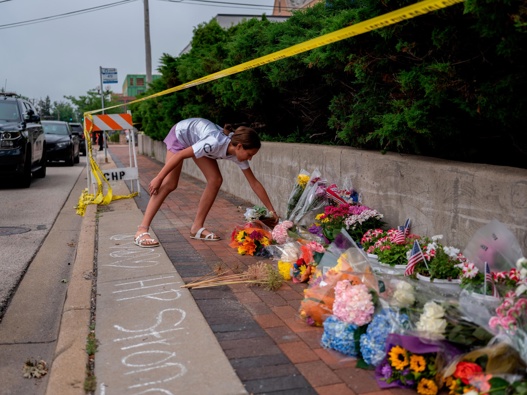 A mourner visits a memorial for the victims of a mass shooting at a Fourth of July parade, in Highland Park, Illinois. (Photo / Getty Images)