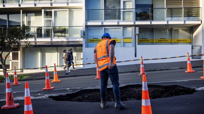A contractor at the College Hill sinkhole this morning. Photo / Carson Bluck