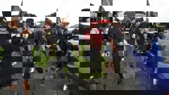 Shayden Perkinson's loved ones, alongside hīkoi organiser Zee Tana, wave flags in the late man's honour. Photo / Michael Cunningham