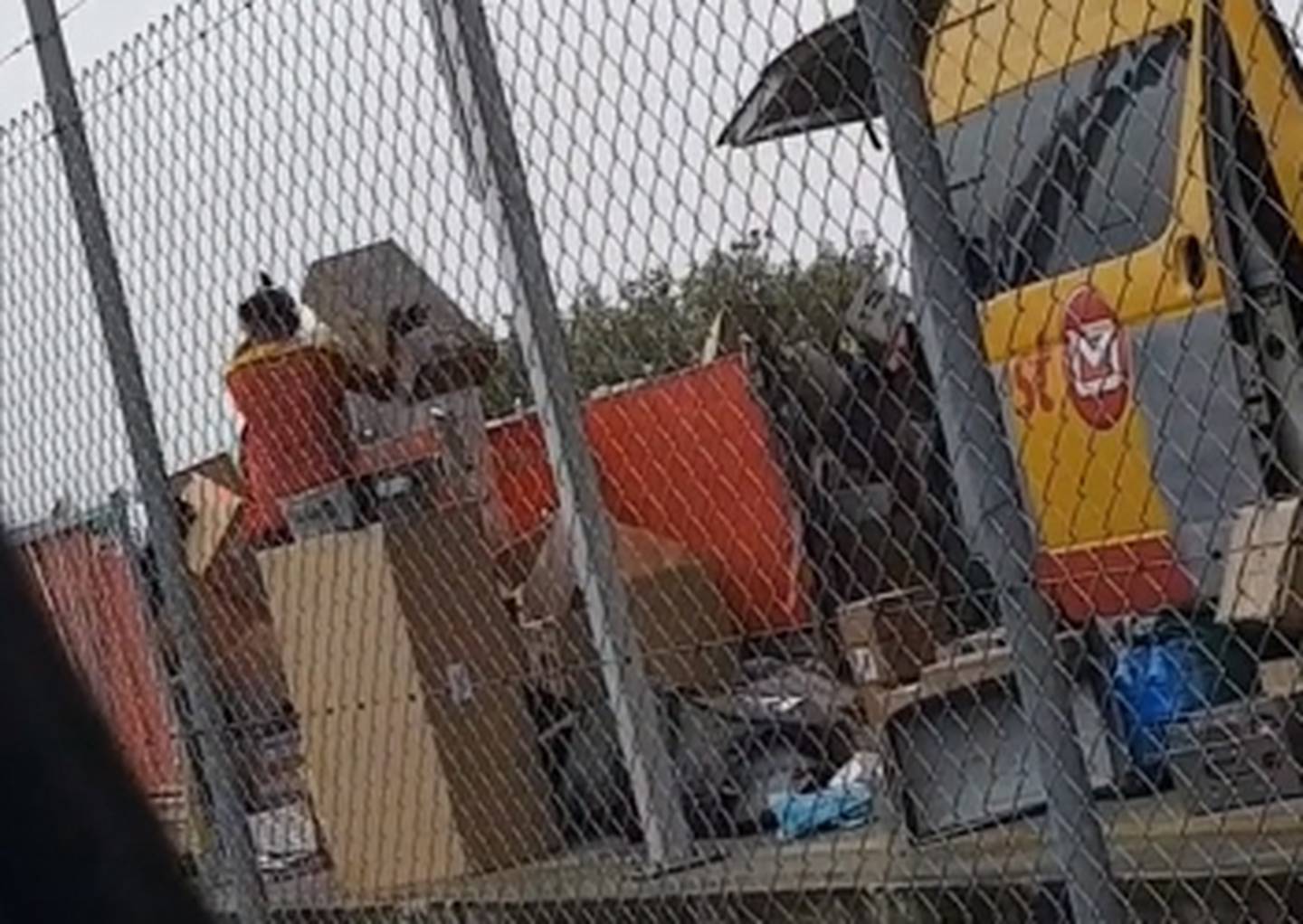 The workers was seen tossing the packages between two bins at the depot. (Photo / Samantha Wilson)