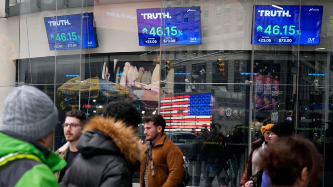 Pedestrians walk past the Nasdaq building as the stock price of Trump Media & Technology Group Corp is displayed earlier this year. Photo /Frank Franklin II, AP, File