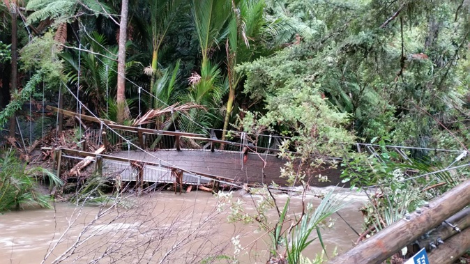 A bridge in the Waitakere Ranges was destroyed on Saturday as more than 27mm of rain fell in one hour. (Photo: Supplied)