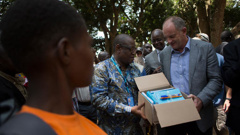 United Nations Special Representative for South Sudan David Shearer (right) and UNICEF Representative in South Sudan Marimba Mdoe (centre) distribute books and pens to children formerly associated with an armed group. (Photo/ Karel Prinsloo)