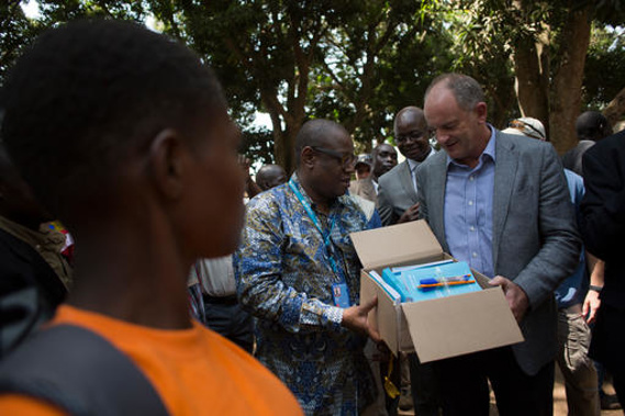 United Nations Special Representative for South Sudan David Shearer (right) and UNICEF Representative in South Sudan Marimba Mdoe (centre) distribute books and pens to children formerly associated with an armed group. (Photo/ Karel Prinsloo)