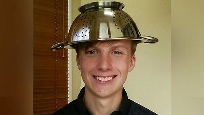 A teenager was reportedly told to remove a colander from his head for a school photo. (Photo / Reddit)