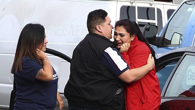 Fernando Juarez, 36, of Napa, center, embraces his 22-year-old sister Vanessa Flores, right, at the Veterans Home of California. (Photo / AP)