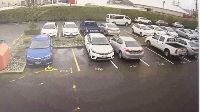 CCTV footage released to the Herald shows a white van (top) driving through EQC's Christchurch staff car-park spraying paint stripper over cars. (Photo / supplied)