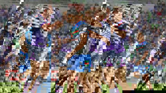 Christian Welch of the Melbourne Storm is congratulated by his teammates after scoring a try as Peta Hiku of the Warriors looks on (Photo / Getty Images)