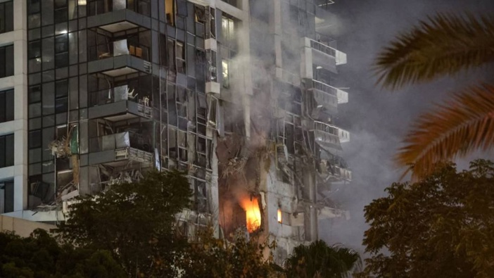 Fire and smoke rise from a building, reportedly hit by a missile fired from Iran, in central Tel Aviv. Photo / Jack Guez, AFP