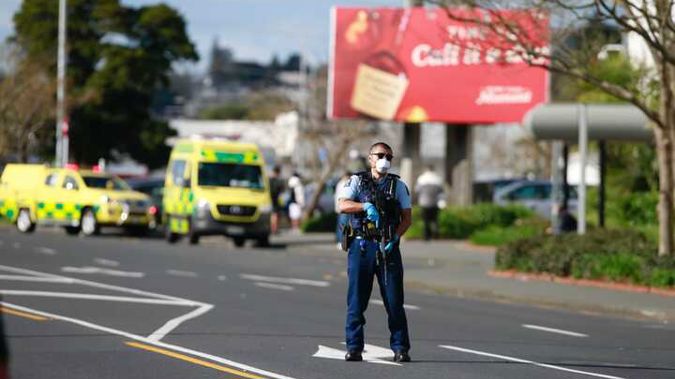 A police officer outside LynnMall in west Auckland after an incident at Countdown. (Photo / Alex Burton)