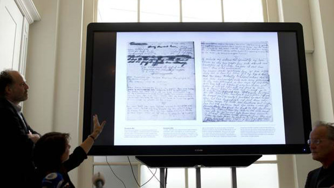 A video shows the text underneath two taped off pages from Anne Frank's diary. (Photo / AP)