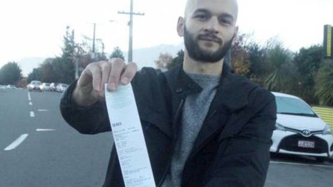 Marco Adreani with one of the tickets he has been issued in Queenstown. (Photo / Mandy Cooper)