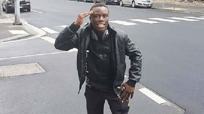 Missing Cameroon athlete Simplice Fotsala salutes the camera while standing on a street in Melbourne's CBD. (Photo / Facebook)