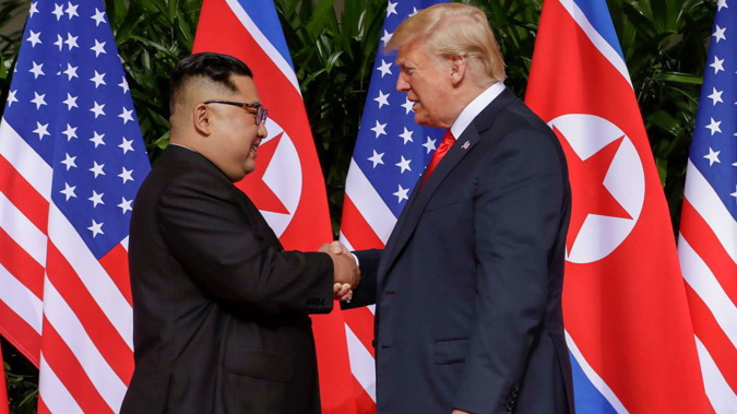Kim Jong Un and Donald Trump shake hands for the cameras as the world watches. Photo / AP