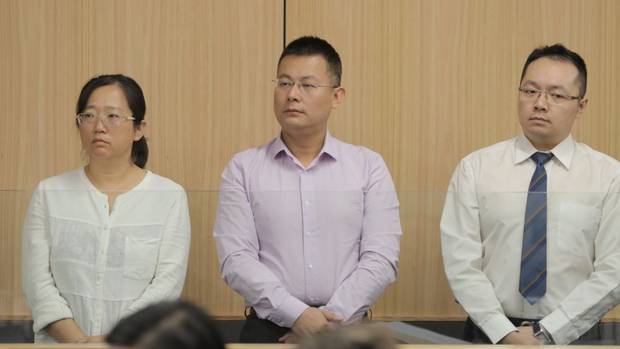 Kang Xu, lawyer Gang Chen and former banker Zongliang Jiang pictured during the start of their trial. (Photo / Michael Craig)
