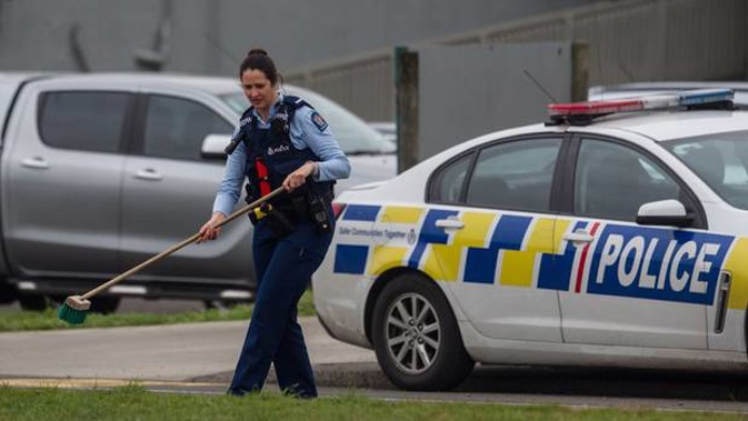 Police sweep up glass near at the scene on Old Taupo Rd. Photo/Stephen Parker