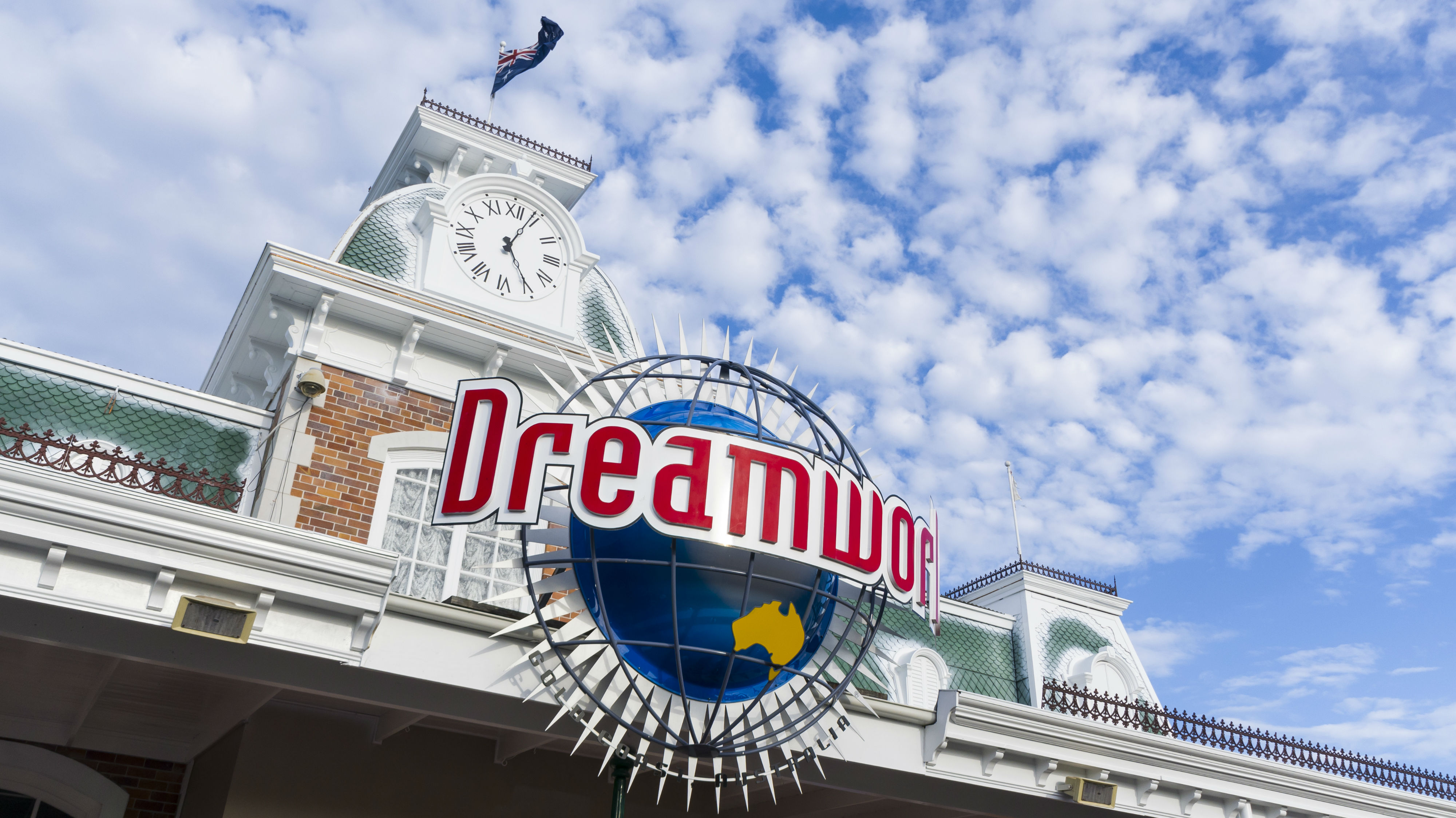  The Facade of Dreamworld Gold Coast entrance building, Australia National flag flying against the beautiful clouds and blue sky. Photo / Getty Images