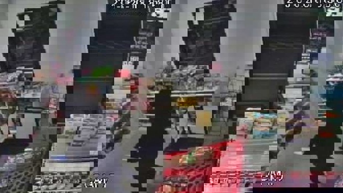A male wearing black and carrying a large knife is captured on CCTV footage at Brookfield Superette. Photo \ Supplied