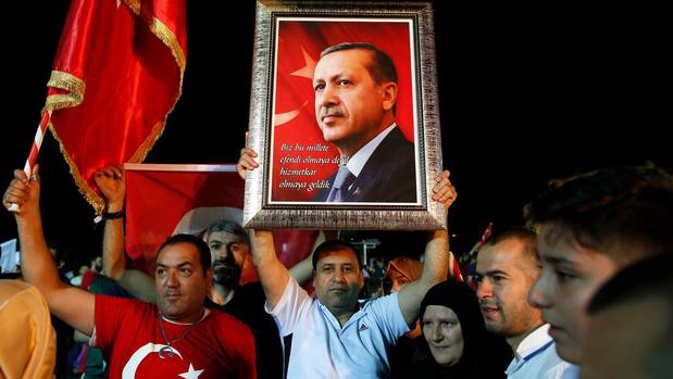 Supporters of Turkey's President Recep Tayyip Erdogan listen as he addresses them outside his official residence in Istanbul. Photo / AP