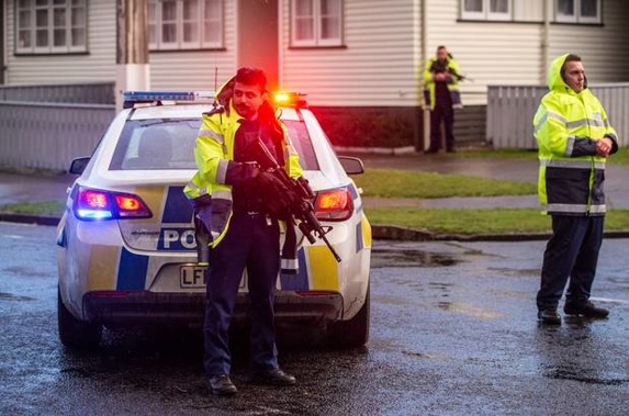 Armed officers standing guard at the police cordon after a shooting at a house in George Street, Stokes Valley, Lower Hutt. (Photo / NZ Herald)