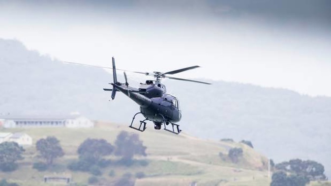 Under its eye: the police Eagle helicopter. New Zealand Herald Photograph by Greg Bowker