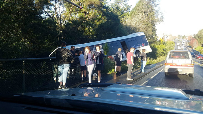 A school bus in Albany has tipped off the road this afternoon. (Photo / Supplied)
