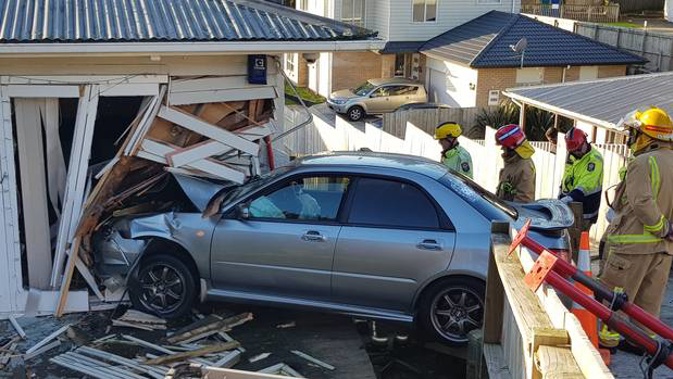 The car went through two fences and into a property on the corner of Penrose Rd and Young Rd around 3.30pm. Photo / Sam Sword