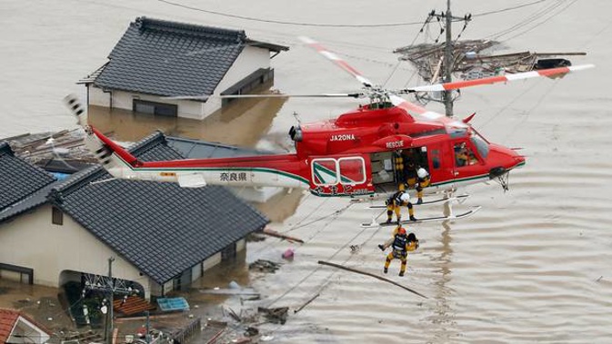 A resident is rescued in a flooded area in Kurashiki, Okayama prefecture, following days of heavy rain in Japan. Photo / AP