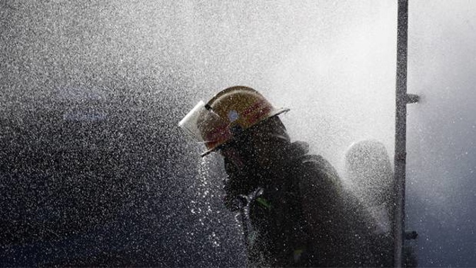 Fire services at the scene on a chemical fire at Te Pai Place in Henderson. (Photo / Jason Oxenham)