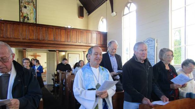 Reverend Chris Swannell enters his reception as Presider of the Holy Eucharist, Christ Church, Russell, on Sunday - the first New Zealander in an openly gay relationship to become an Anglican priest.