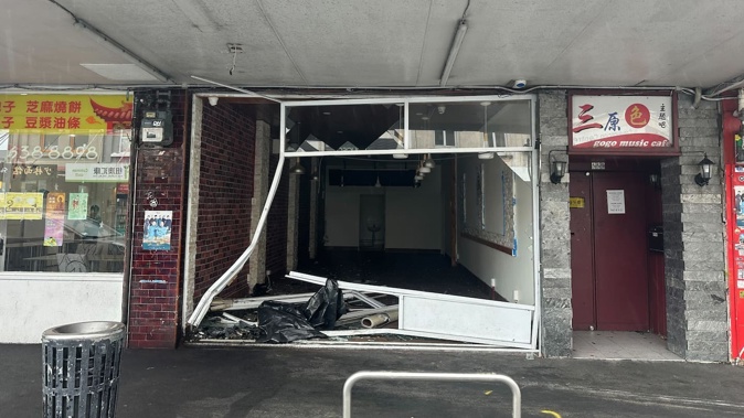 A car collided with another vehicle and smashed into a storefront on Dominion Rd in the early hours of this morning. The driver fled on foot. The other driver was killed and a passenger is in a critical condition. Photo / Rachel Maher