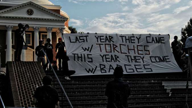 The powerful banner was unfurled at a rally to mark the one year anniversary. (Photo / Getty)