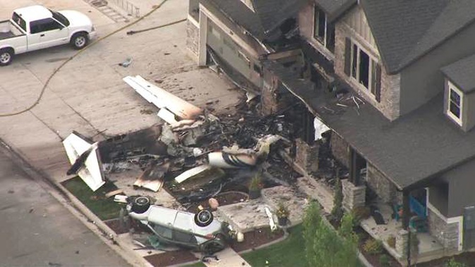 This frame from video shows the scene of a small plane that crashed into a house in Payson, Utah. (Photo / AP)