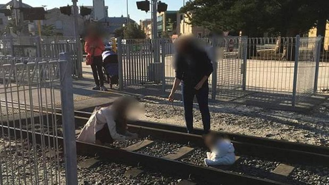 A photo has emerged on social media of a baby sitting in the middle of train tracks in Australia. (Photo / The Bell Tower / Twitter)