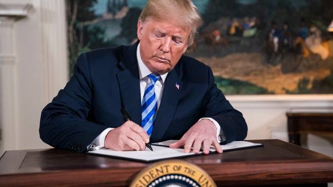 President Donald Trump signs a memorandum withdrawing the US from the Iran nuclear deal. Photo / Washington Post