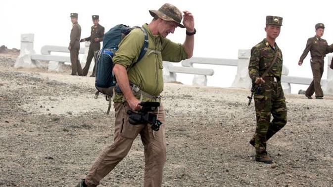 New Zealander Roger Shepherd of Hike Korea walks past North Korean soldiers while leading a hike on Mount Paektu in North Korea. Photo / AP