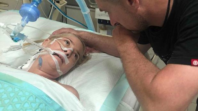 Abby Hartley in hospital in Bali with husband Richard at her side. (Photo / Supplied)